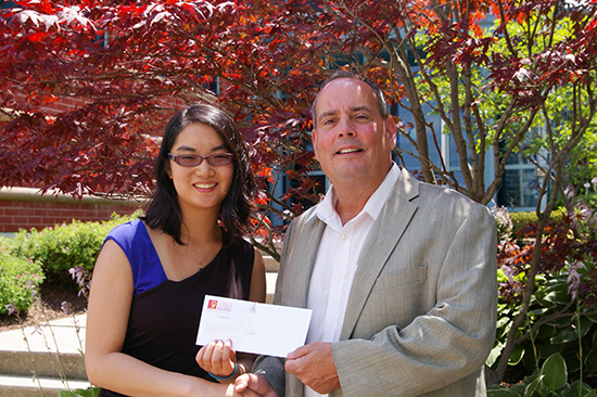 2017 President Jim Smith hands in the scholarship cheque to Amy Tai