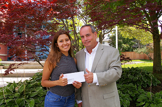 2017 President Jim Smith hands in the scholarship cheque to Natalia Pineda