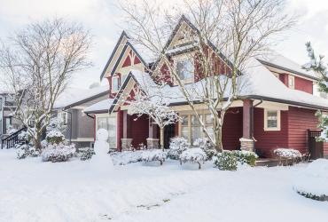 House in winter with snowman