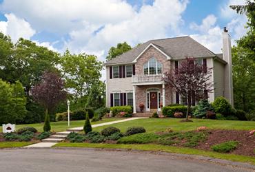 A modern custom-built luxury home in a cul-de-sac in a residential neighborhood