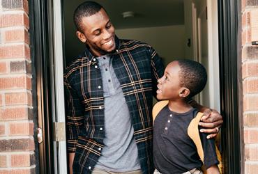 Father and son at front door